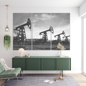 May include: A black and white photo of three oil derricks pumping oil in a field. The photo is split into three panels.
