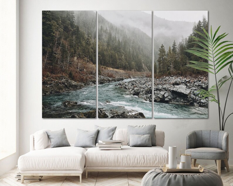 May include: A misty forest scene with a river flowing through it. The river is surrounded by rocks and trees. The scene is captured in a three-panel canvas print.
