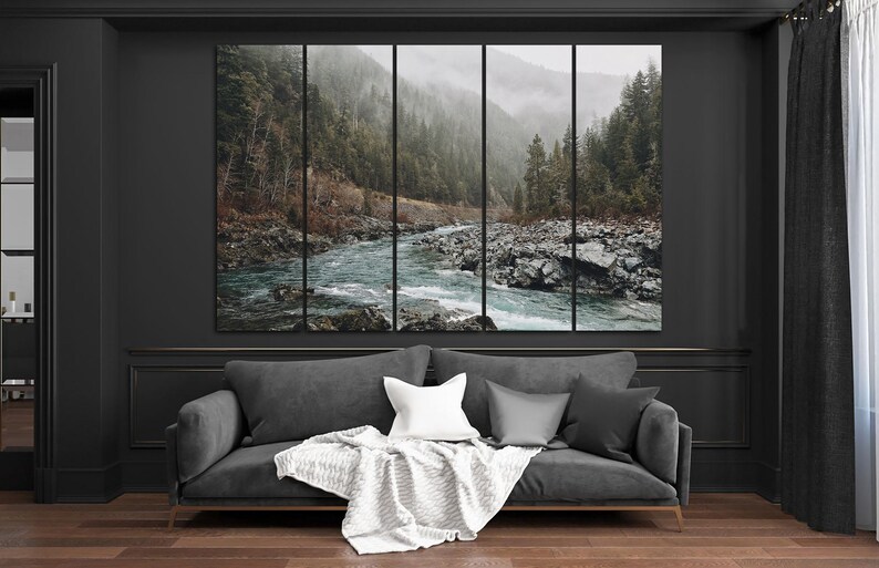 May include: A panoramic photograph of a river flowing through a lush green forest. The river is surrounded by rocks and the forest is covered in mist. The photograph is split into five panels.