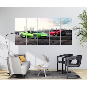 May include: A five-panel wall art set featuring two luxury sports cars. One is a bright green convertible, and the other is a red coupe. The cars are parked on a concrete surface with a city skyline in the background. The artwork is displayed in a modern living room setting.