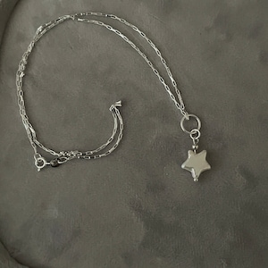 Colgante de plata de ley con perla cultivada en agua dulce y forma de estrella