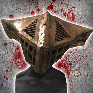 May include: A weathered, cage-like helmet with a rusty brown finish. The helmet features a square design with a slatted front and top, suggesting a medieval or fantasy theme. The background has a grunge texture with red splatter.