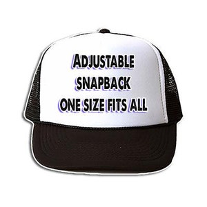 May include: White trucker hat with black mesh back. The hat has black text that reads "Adjustable Snapback One Size Fits All" with the words "Snapback" and "One Size Fits All" in purple.