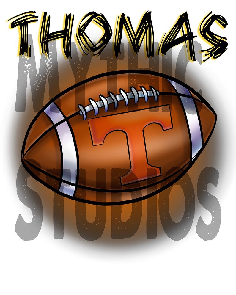 May include: A brown and white football with a large orange "T" on the side. The football is surrounded by the words "THOMAS MYSTIC STUDIOS" in black and yellow.