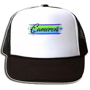 May include: A white trucker hat with a black mesh back. The front of the hat has a green, blue, and white design with the name "Cameron" written in black.