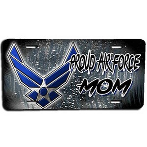 May include: A black and silver license plate with a blue Air Force logo and the text "Proud Air Force Mom".
