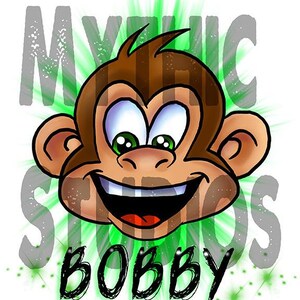 May include: A cartoon monkey with a big smile and green eyes. The monkey is surrounded by a green and white starburst. The text "Mythic Studios Bobby" is written below the monkey.