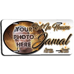 May include: A gold and white memorial license plate with a photo placeholder, the text "Rest In Heaven Jamal", and the dates "Sunrise 1-20-1990" and "Sunset 2-6-2001".