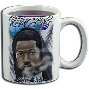 May include: White ceramic coffee mug featuring a black and white portrait of a man with the text "R.I.P. Biff 1991-2016" printed on the front.