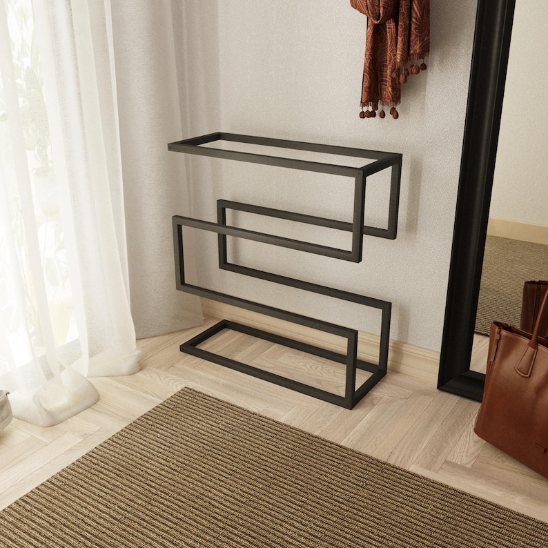 Black metal shoe organizer with a minimalist design, ideal for keeping shoes and umbrellas neatly stored