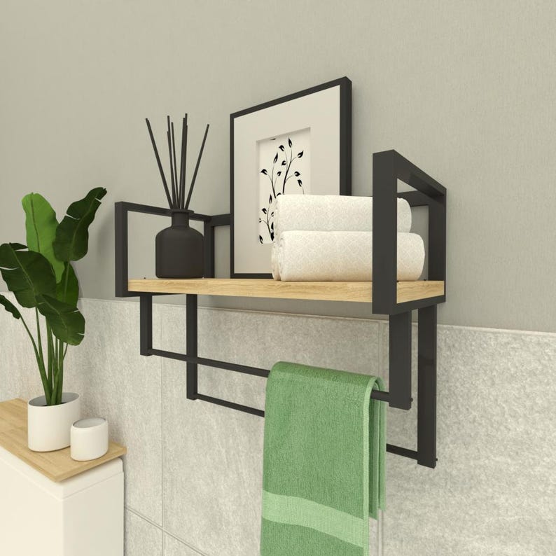 Modern wall-mounted metal and wood bathroom shelf with a towel rack, perfect for organizing hand towels and toiletries