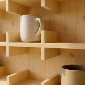 Coffee bar mug display shelf designed for organizing ceramic coffee cups