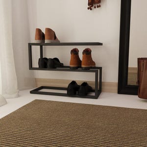 Black metal shoe organizer with a minimalist design, ideal for keeping shoes and umbrellas neatly stored