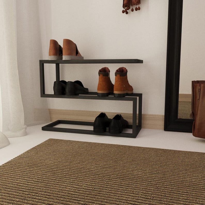 Black metal shoe organizer with a minimalist design, ideal for keeping shoes and umbrellas neatly stored