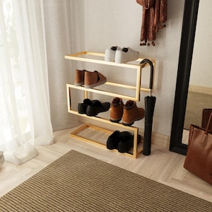 Entryway shoe storage solution with sleek gold metal finish and integrated umbrella stand