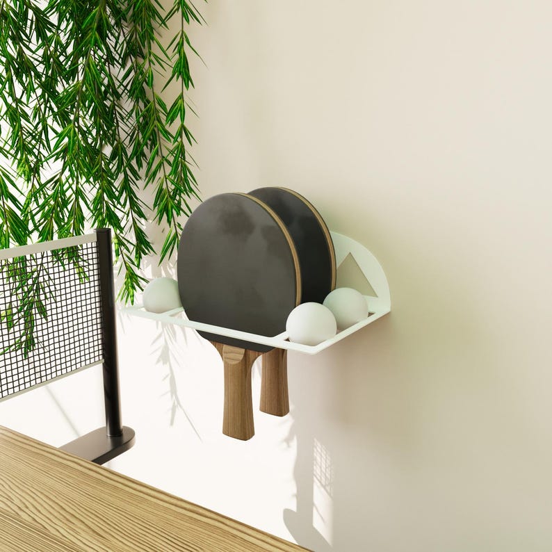 Minimalist table tennis paddle and ball holder, black metal wall shelf with geometric Squid Game-inspired design for gamers and fans