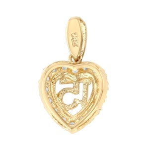 May include: Gold heart-shaped pendant with a detailed Om symbol inside. The pendant has a bail for attaching to a chain.