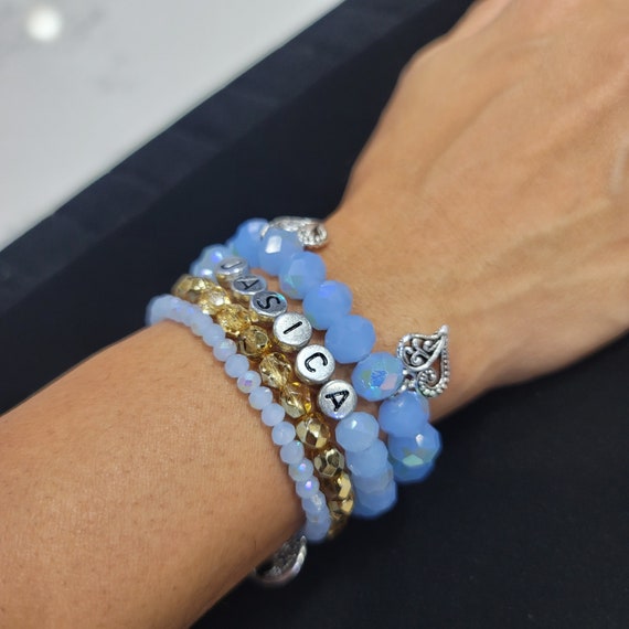 Personalized 4 Bracelet Set of Light Blue Faceted Glass Beads and seed beads with Gold metallic beads on one band. Comfort stretch bands
