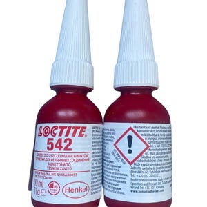May include: Two 10 ml bottles of red Loctite 542 thread sealant. The bottles have white caps and a warning label with a red exclamation point.