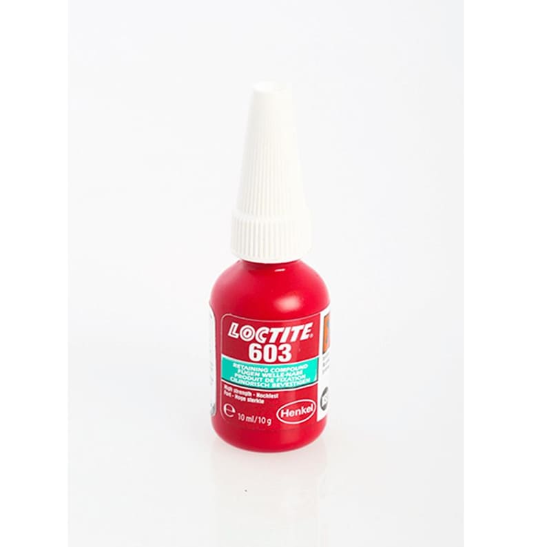 May include: A red bottle of Loctite 603 retaining compound. The bottle is labeled with the product name and a description of its use. The bottle is 10 ml/10 g.