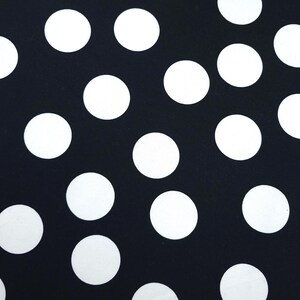 May include: A black background is covered with large, evenly spaced white polka dots. The dots are circular and opaque, creating a high-contrast pattern. This design is suitable for various applications, including fabric, wallpaper, or wrapping paper.