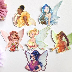 May include: Six colorful fairy stickers with glitter accents. Each sticker features a different fairy with wings and a unique design. The fairies are depicted with different hair colors, skin tones, and clothing.