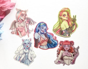 May include: Five colorful stickers featuring different female characters with unique hairstyles and outfits. The stickers are printed on a white background.