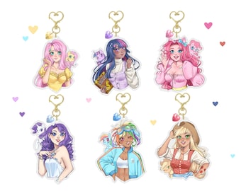 May include: Six colorful acrylic keychains featuring cartoon characters from the My Little Pony franchise. Each keychain features a different character with a small pony companion. The characters are depicted in a human-like form with unique outfits and hairstyles.