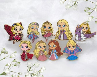 May include: Set of nine enamel pins featuring various Barbie characters in princess and fairy costumes. The pins are colorful and feature glitter accents. The characters include a fairy, a mermaid, a ballerina, a princess, and a unicorn.