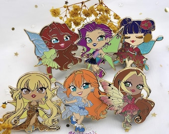 May include: Six enamel pins featuring cartoon fairies with colorful wings and dresses. The fairies have different hair colors and styles, and each pin has a different design. The pins are all gold-toned and have a shiny finish.
