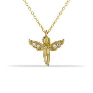 May include: A gold necklace with a small cherub pendant adorned with clear cubic zirconia stones.