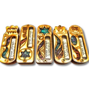 May include: Five wooden boxes with clear glass windows and a small scroll inside. Each box has a different design and is decorated with colorful stones. The text on the scrolls reads "Tefilat HaDerech" which means "Prayer on the Way".
