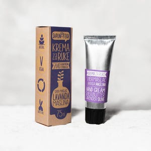 May include: A 75ml hand cream tube and its matching cardboard box. The packaging is brown with purple labels featuring the text SAPUNOTEKA KREMA ZA RUKE SHEA MASLAC LAVANDA MASLINA. The tube is silver with a black cap and a purple label.