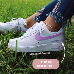 white nike shoes with purple swoosh