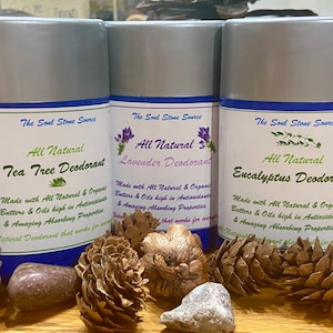 May include: Three silver deodorant sticks with blue labels. The labels read "The Soul Stone Source" and list the scents "Tea Tree Deodorant", "Lavender Deodorant", and "Eucalyptus Deodorant". Each label states "All Natural" and "Made with All Natural & Organic Butters & Oils high in Antioxidants & Amazing Absorbing Properties."