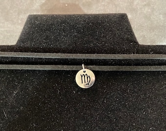 Stainless Steel Zodiac Pendant Choker on Dual Black Faux Leather Necklace Bands with adjustable steel chain. Astrology sign