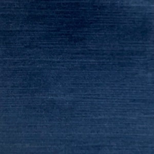 May include: A dark blue fabric with a subtle textured pattern. The fabric has a smooth, even surface and a rich, deep blue color.