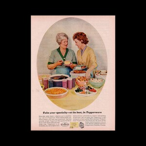 May include: Two women are preparing a buffet table with a variety of dishes in colorful Tupperware containers. The text "Take your specialty - at its best, in Tupperware" is at the bottom of the image.