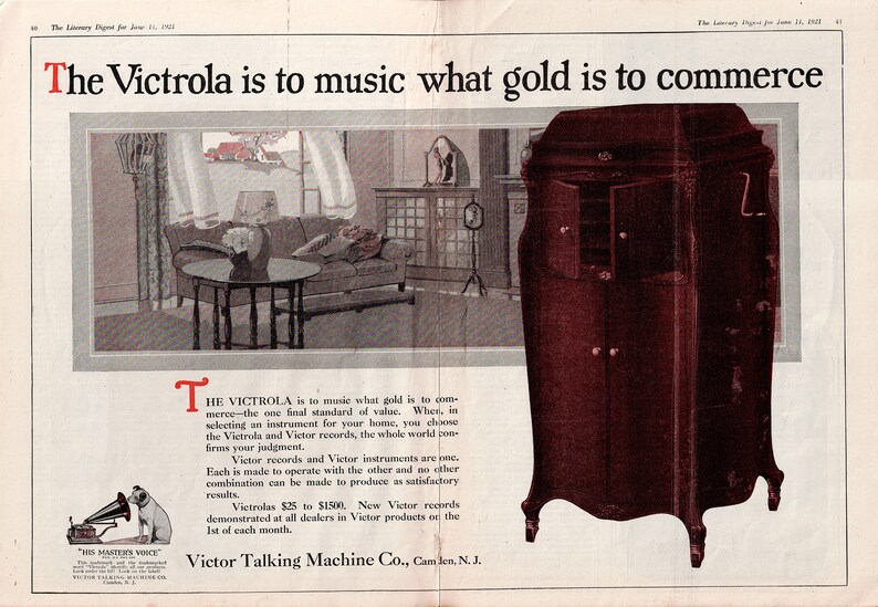 Vintage 1921 Victrola Victor Talking Machine double‑page advertisement featuring a living‑room scene with a Victrola phonograph, a detailed cabinet illustration, and the His Master’s Voice logo. Includes the headline “The Victrola is to music what gold is to commerce.” Large 12×17.5 centerfold with center crease and staple marks, in good vintage condition.