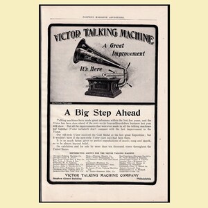 May include: An advertisement for the Victor Talking Machine, featuring a black and white image of a gramophone. The ad includes the text "A Great Improvement" and "It's Here". Below the image, the text reads "A Big Step Ahead".