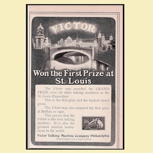 May include: Vintage advertisement for the Victor Talking Machine Company, featuring a black and white image of a bridge and buildings. The ad text states "Won the First Prize at St. Louis" and highlights the machine's awards.