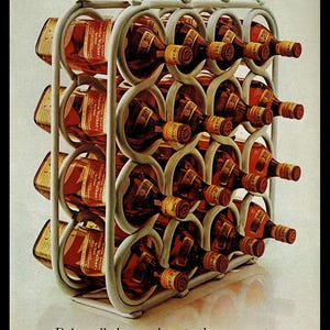 May include: A metal wire rack filled with bottles of Johnnie Walker Red Label Scotch whisky. The bottles are arranged in rows and are all facing the same direction. The rack is sitting on a white surface. The text "100% Scotch Whiskies. 86.8 Proof. Imported by Somerset Importers, Ltd., N.Y." is printed at the top of the image. The text "Bob really knows how to throw a party. He never runs out of Johnnie Walker Red." is printed at the bottom of the image.