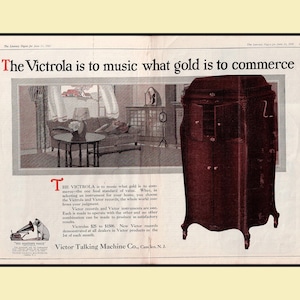 Vintage 1921 Victrola Victor Talking Machine double‑page advertisement featuring a living‑room scene with a Victrola phonograph, a detailed cabinet illustration, and the His Master’s Voice logo. Includes the headline “The Victrola is to music what gold is to commerce.” Large 12×17.5 centerfold with center crease and staple marks, in good vintage condition.