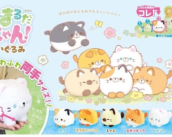 May include: A set of six plush cat toys in various colors and patterns, including a white cat with pink ears, a black and white cat, a brown and white cat, a light brown cat, an orange cat, and a calico cat. The plush toys are all round and have a cute, cartoonish appearance. The text "まんまるだにゃん!" is written in Japanese on the image.