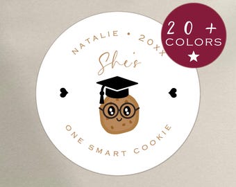 May include: Round white sticker with a brown cookie wearing a graduation cap and glasses. The text "She's One Smart Cookie" is written around the cookie. The text "Natalie 20xx" is at the top of the sticker.  20+ Colors.