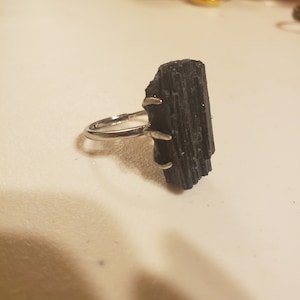 Rough black tourmaline crystal on claw band 925s. Adjustable band.