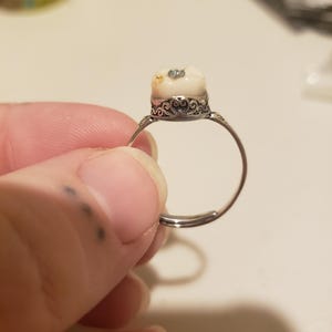Baby tooth with any color gem. Thai silver band adjustable up to 13/14.