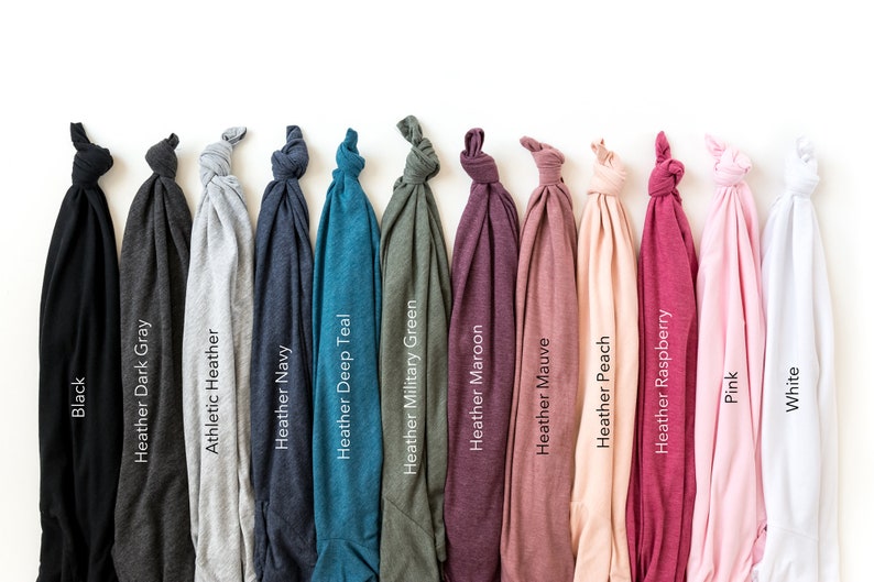 May include: A selection of t-shirts in various colors, including black, dark gray, heather gray, navy, teal, military green, maroon, mauve, peach, raspberry, pink, and white.