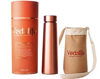 May include: A metallic copper water bottle with a matching cylindrical orange storage tube labeled Vedalife Copper Water Bottle 950 ml and a beige burlap carrying pouch with a shoulder strap and the red Vedalife logo printed on the front.