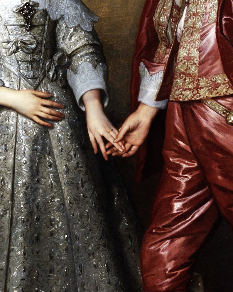 Pu&ograve; includere: Primo piano delle mani di una coppia, la donna indossa un abito con motivo argento e bianco e l'uomo indossa una giacca con motivo rosso e oro. La mano della donna &egrave; adornata da un anello d'oro.